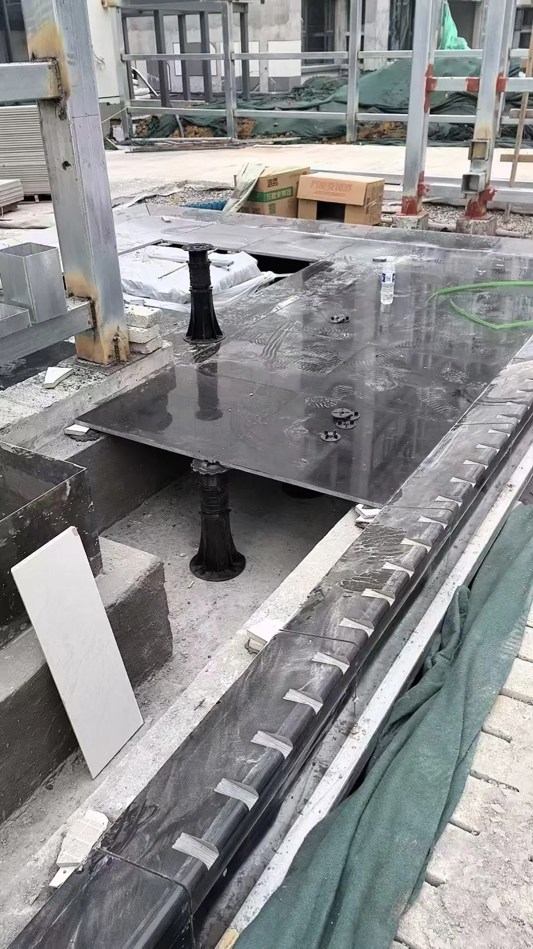 Raised timber deck on adjustable pedestals for a residential development in Slovenia